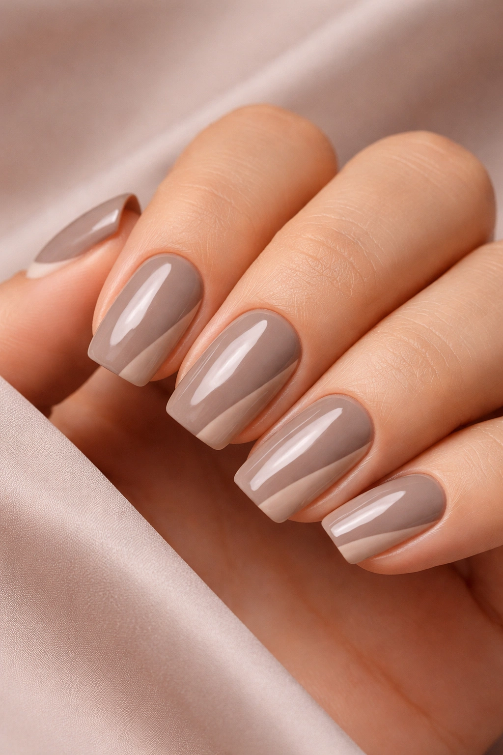 Warm taupe nails with negative space design close-up