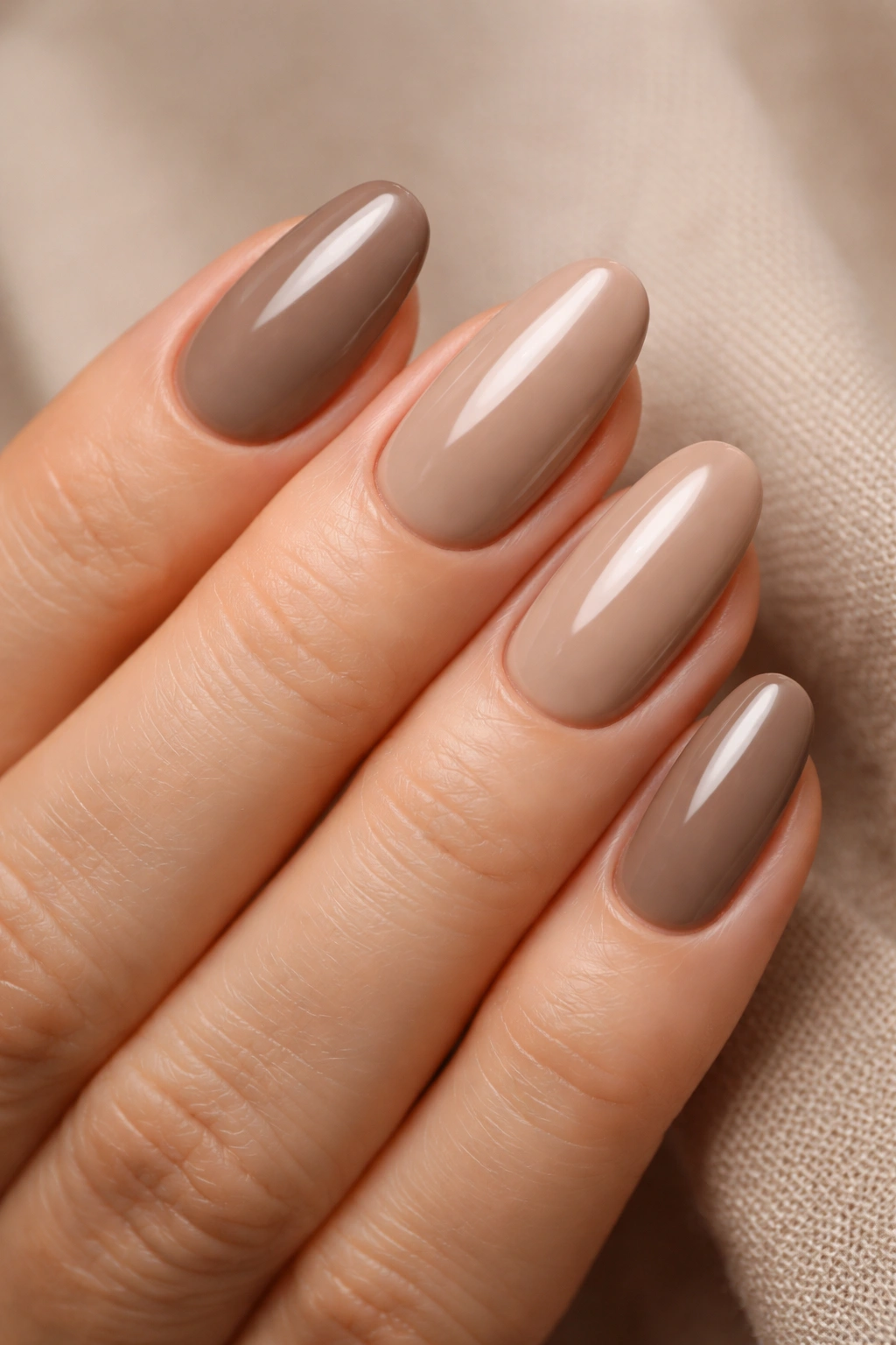 Close-up of hands with taupe and neutral brown nails