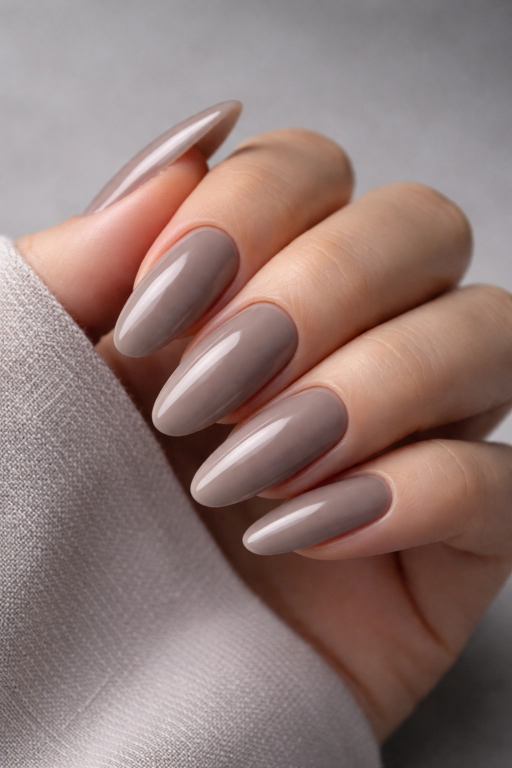 Long oval nails in taupe nude with cool undertone and sculpted look