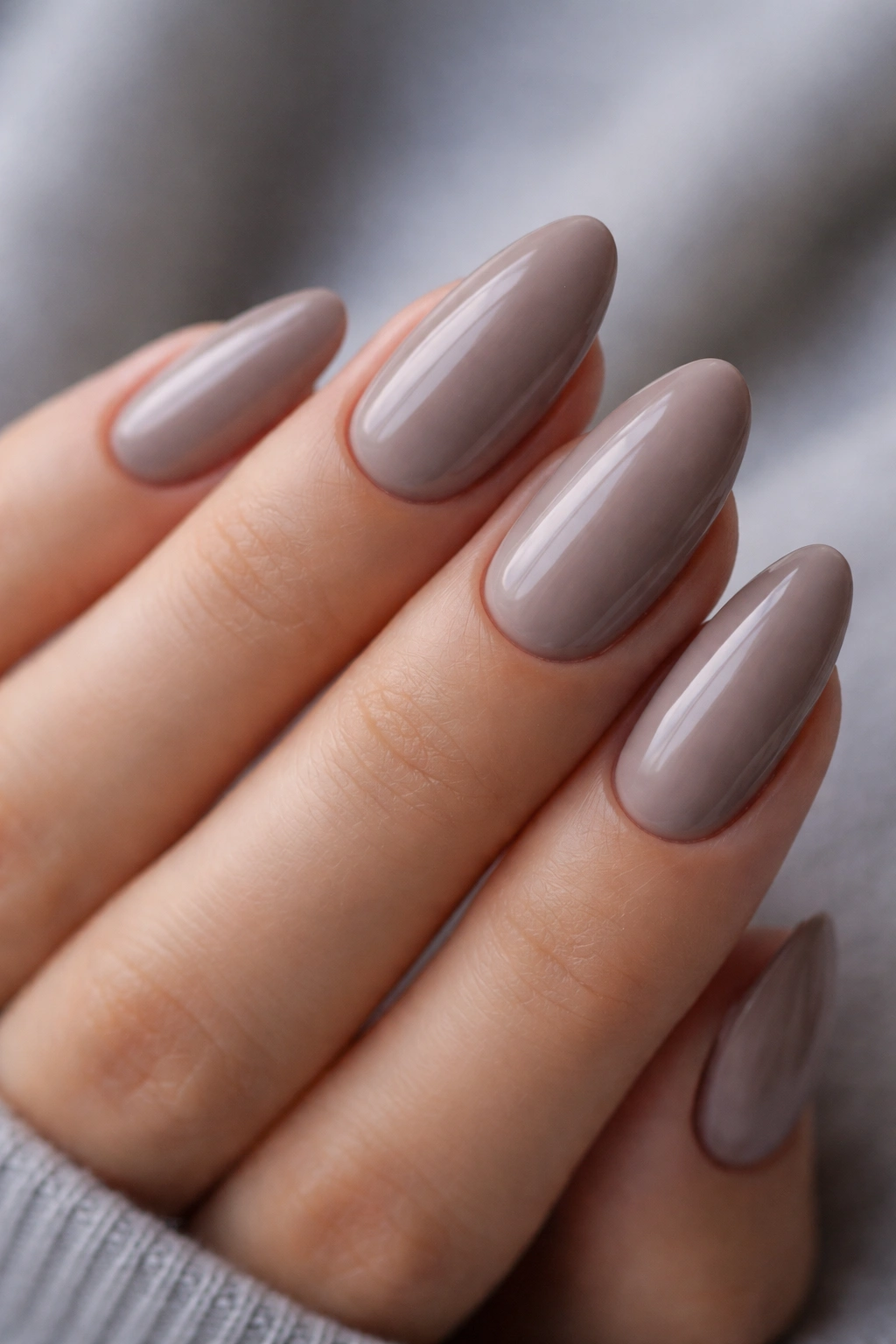 Close-up of taupe nude almond nails with creamy base