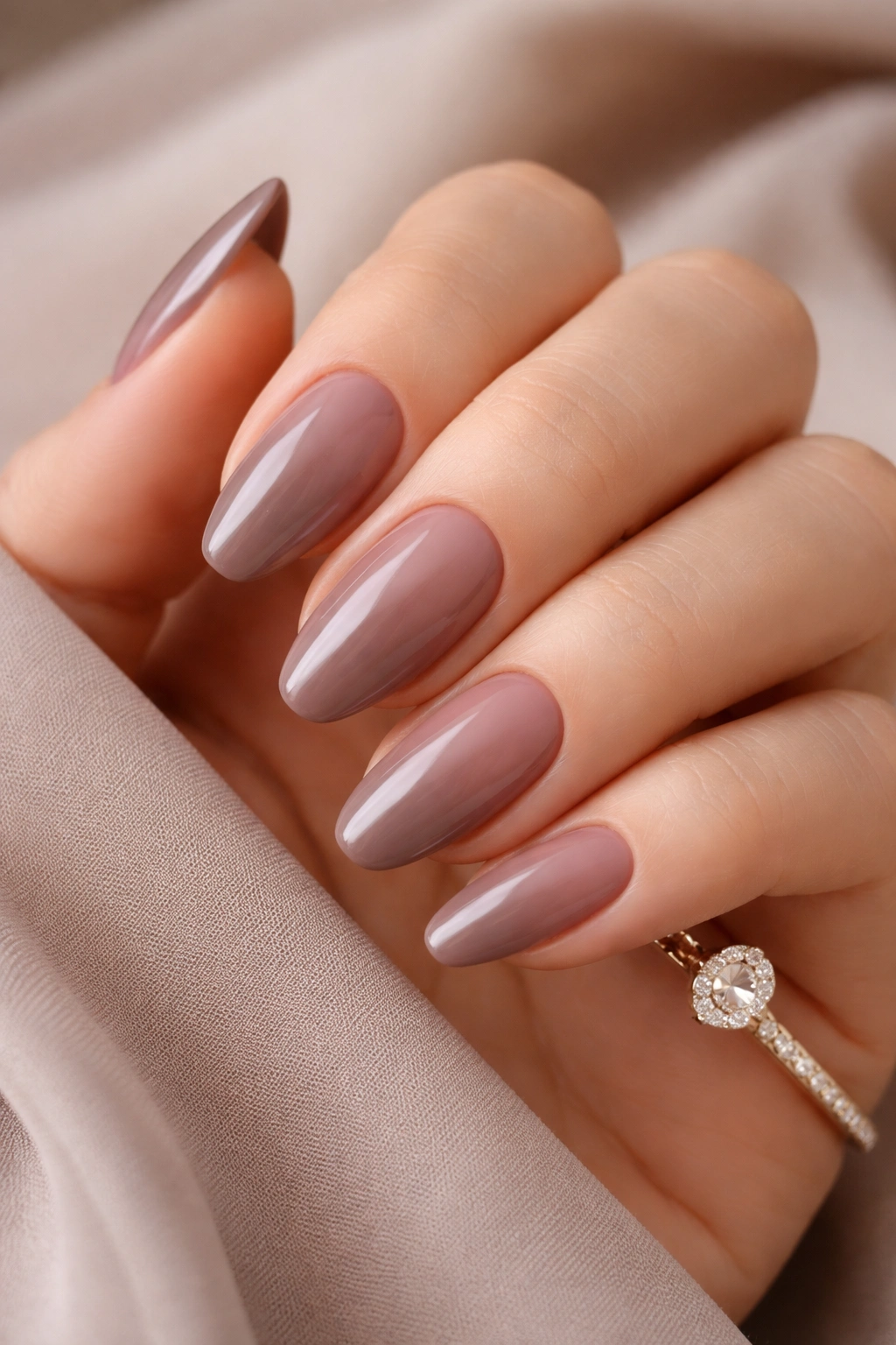 Close-up of taupe and rosy brown nails on a hand