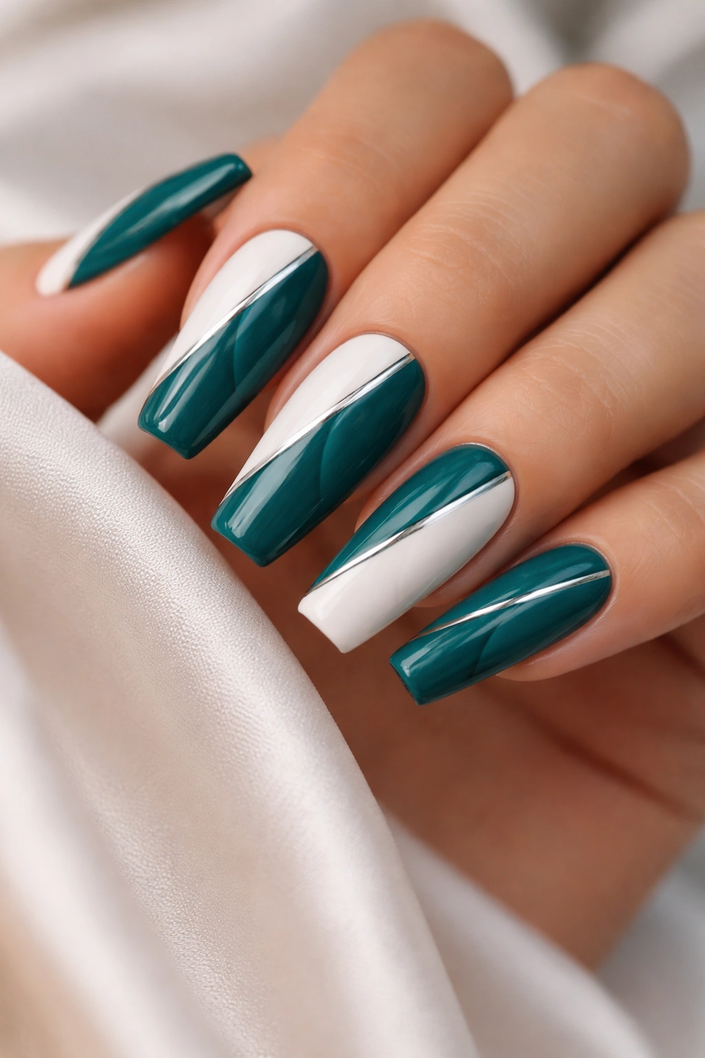Close-up of coffin nails with a diagonal teal split and contrasting color.