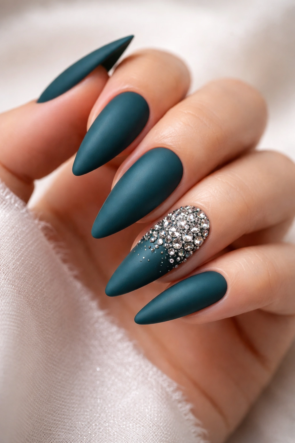 Deep teal matte nails with a rhinestone accent nail