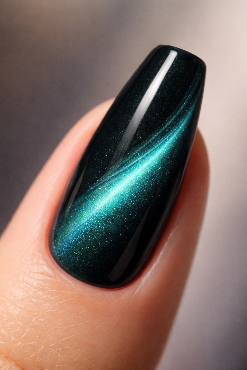 Close-up of teal aurora cat-eye nail with side-swipe on dark base