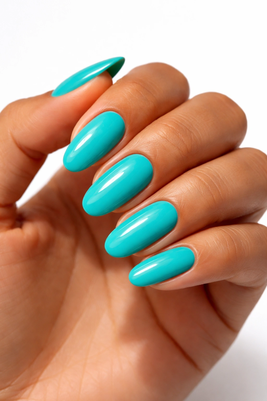 Close-up of hand with bright teal nails on white background