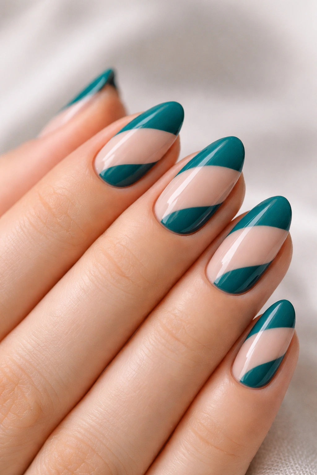 Short almond nails with teal and nude color blocks with crisp edges