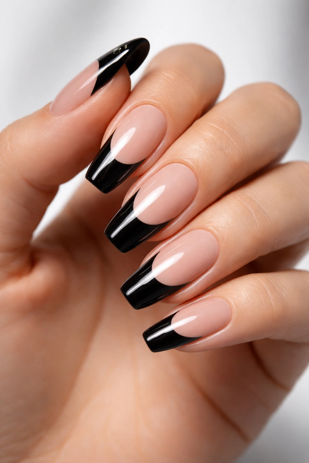 Close-up of hand with thick black tips on nude base