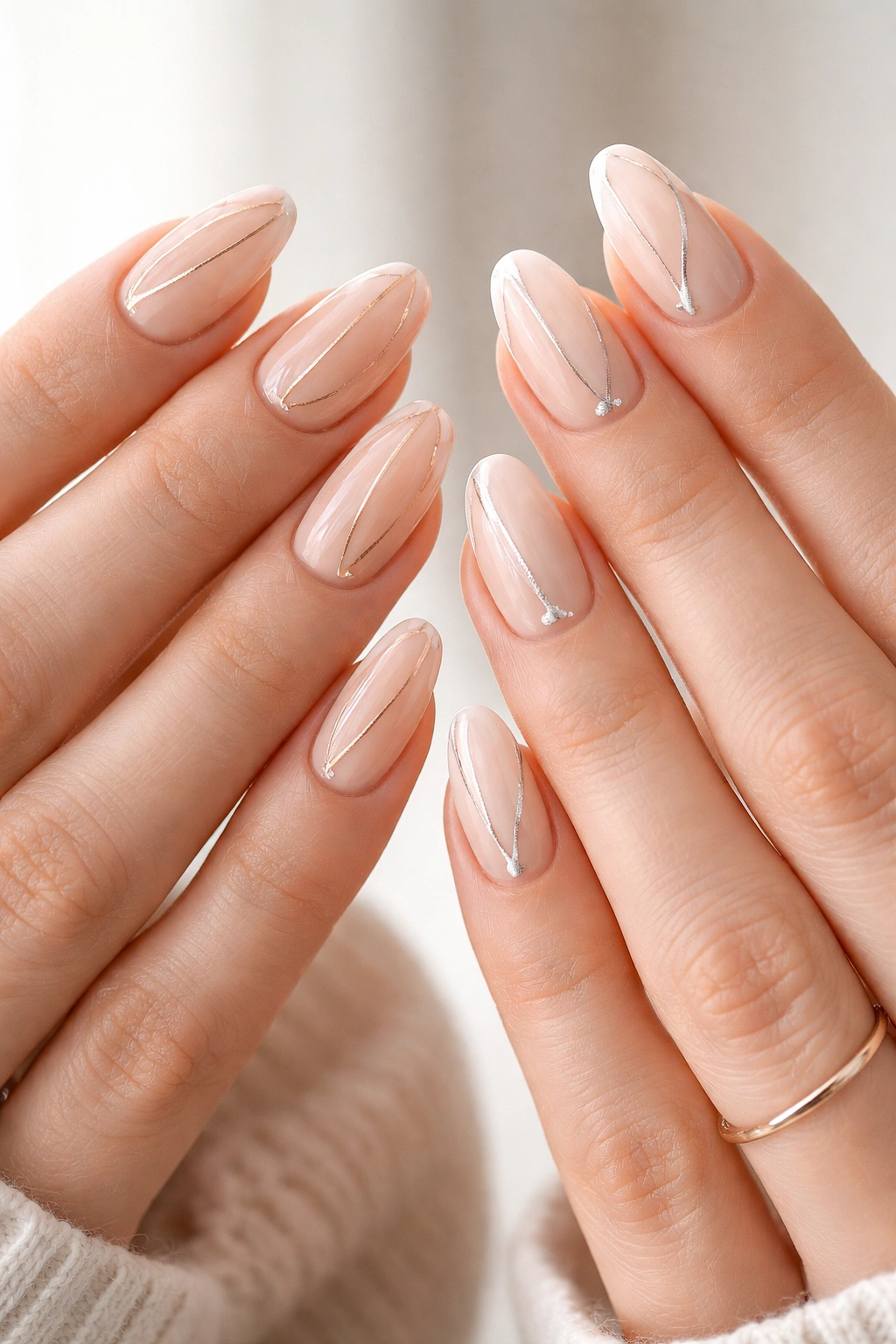 Nails with ultra-thin metallic lines creating a jewelry-like look