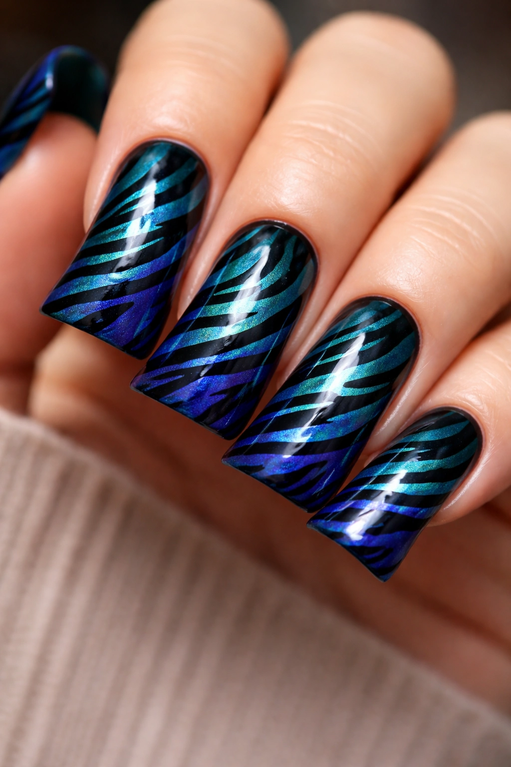Duck nails with jewel-tone tiger stripes on deep teal background