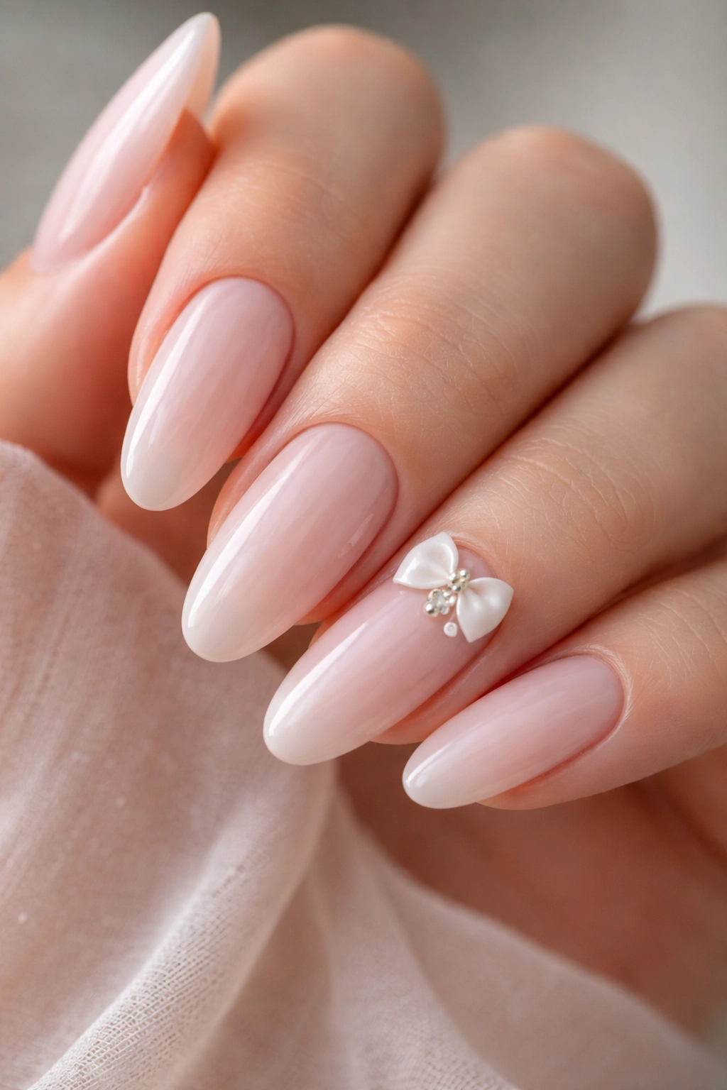 Close-up of one accent nail with a tiny bow or pearl cluster