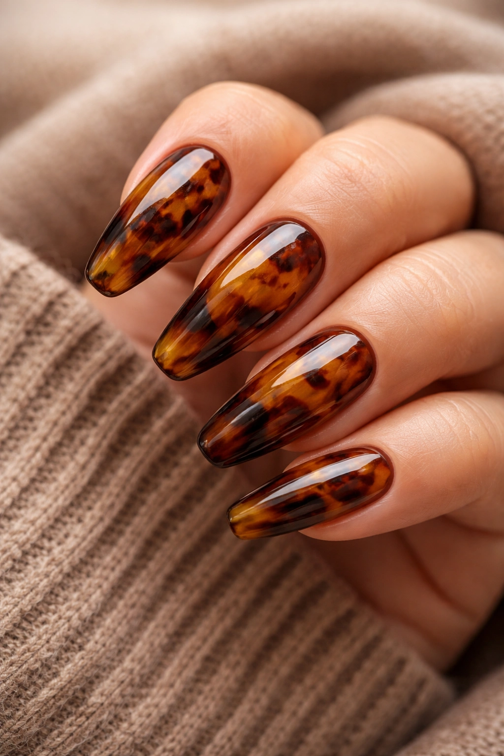 Tortoiseshell patterned nails with amber and brown swirls