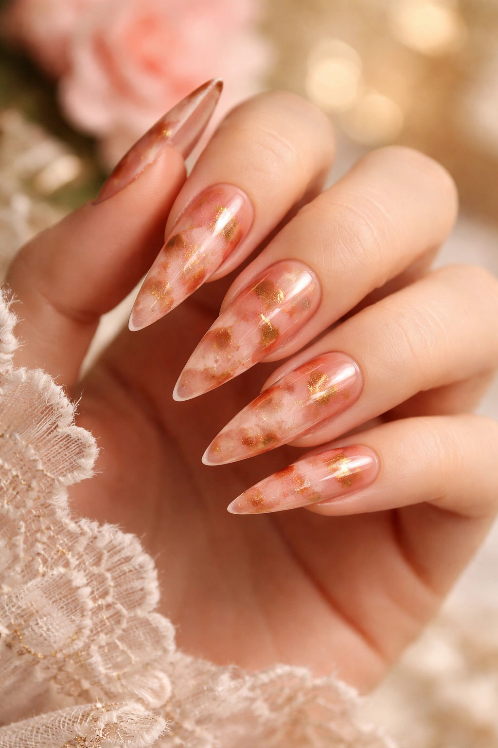 Blush pink stiletto nails with a warm tortoiseshell pattern