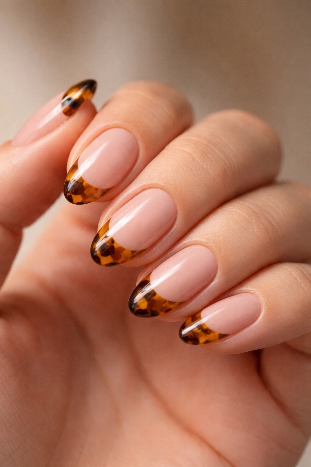 Close-up of tortoiseshell French tips on short almond nails