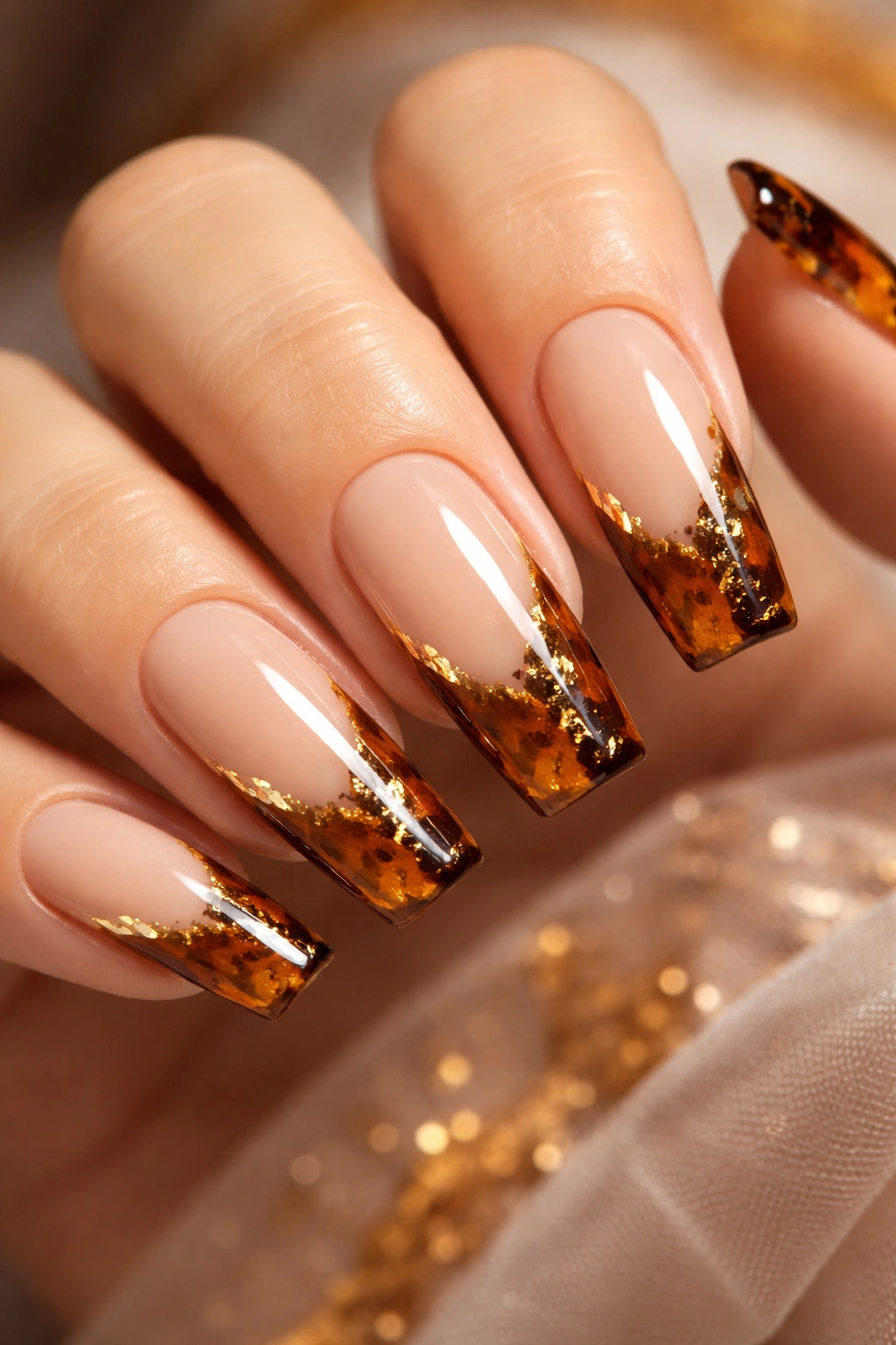 Close-up of coffin nails with tortoiseshell French tips on a nude base