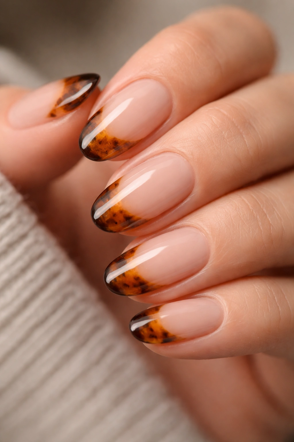 Close-up of tortoiseshell tip nails on nude base