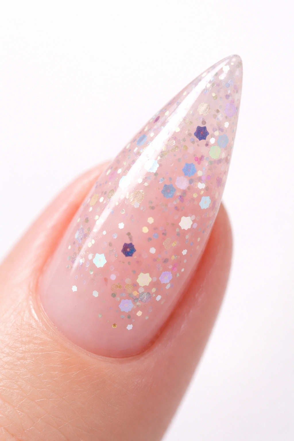 Close-up of a translucent jelly nail with colorful confetti embedded