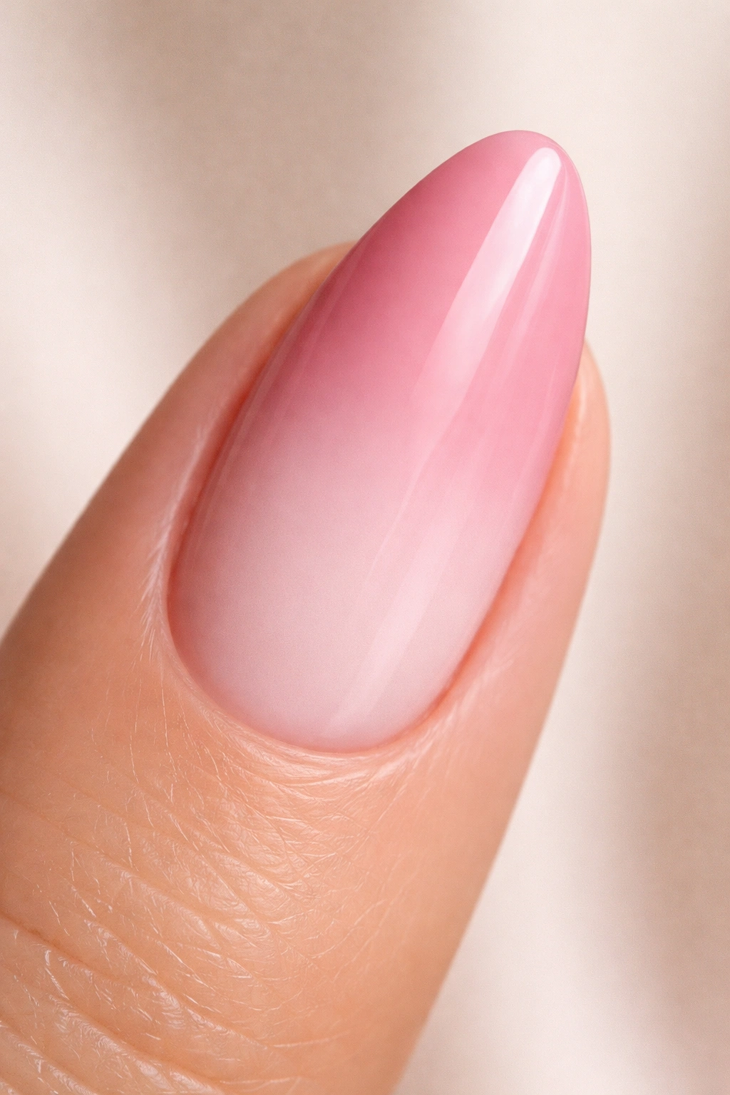 Close-up almond nail with three pink shades gradient from deep rose to pale pink