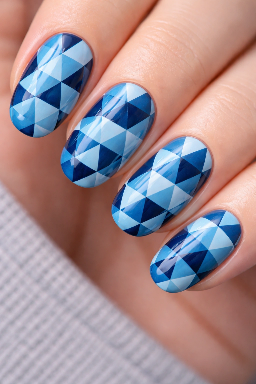 Nails with blue monochrome triangle tessellation pattern