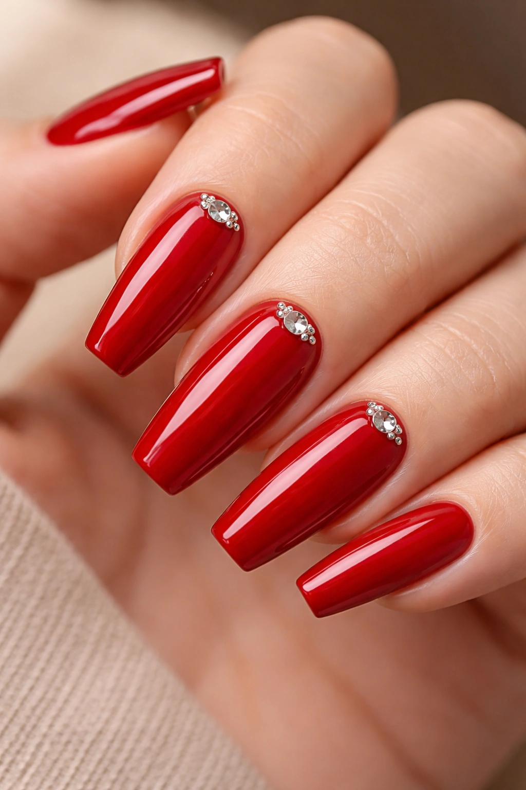 True red nails with crystal cluster at the cuticle on ring finger and thumb