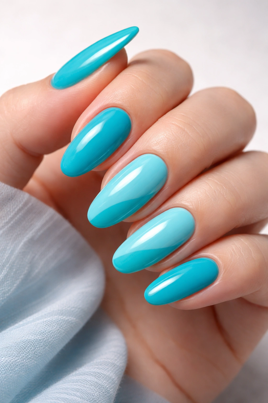 Close-up of turquoise and aqua two-tone nails