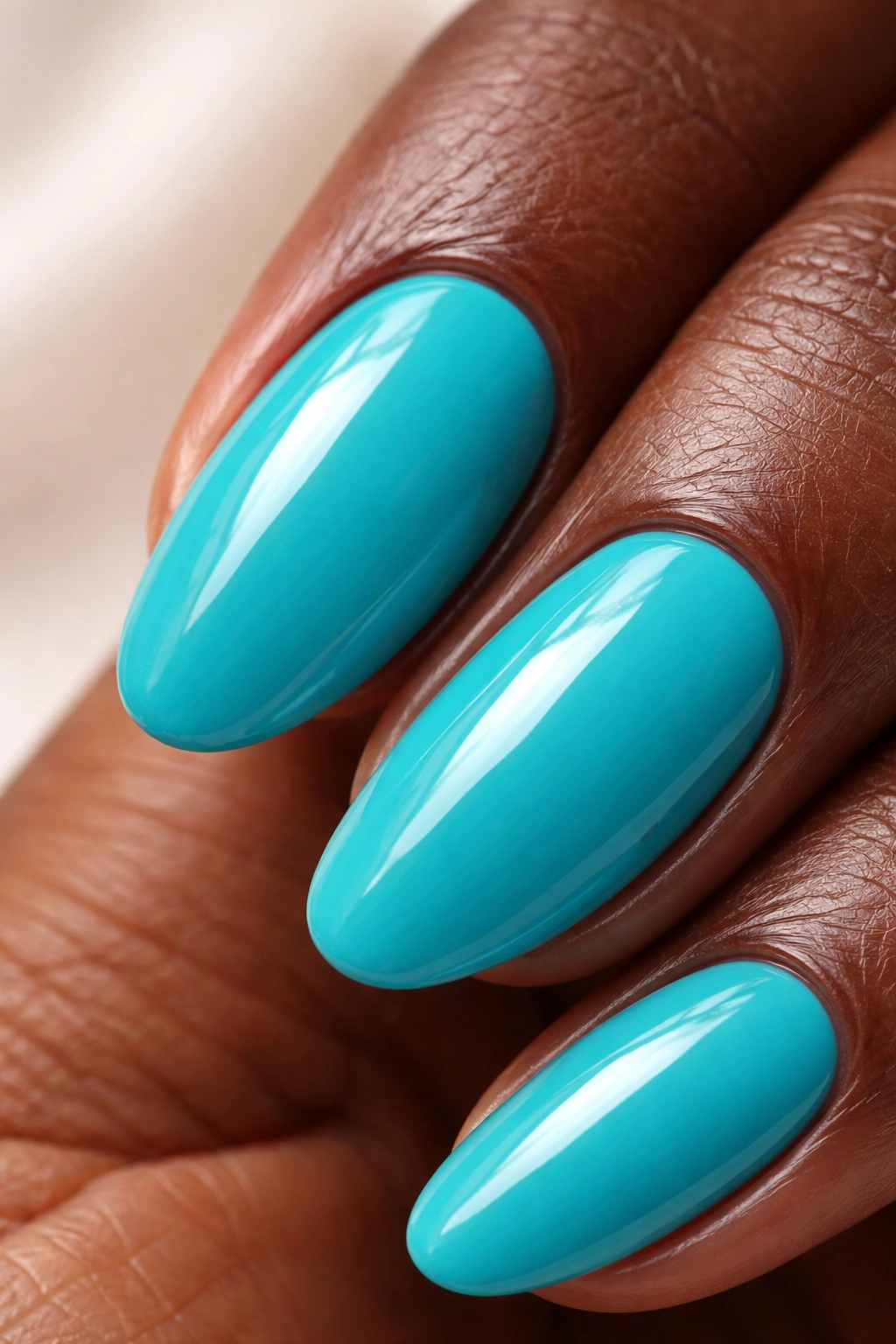 Close-up of a fingernail painted turquoise