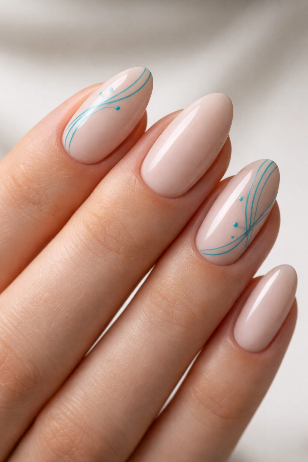 Short almond nails with turquoise abstract line art on nude base
