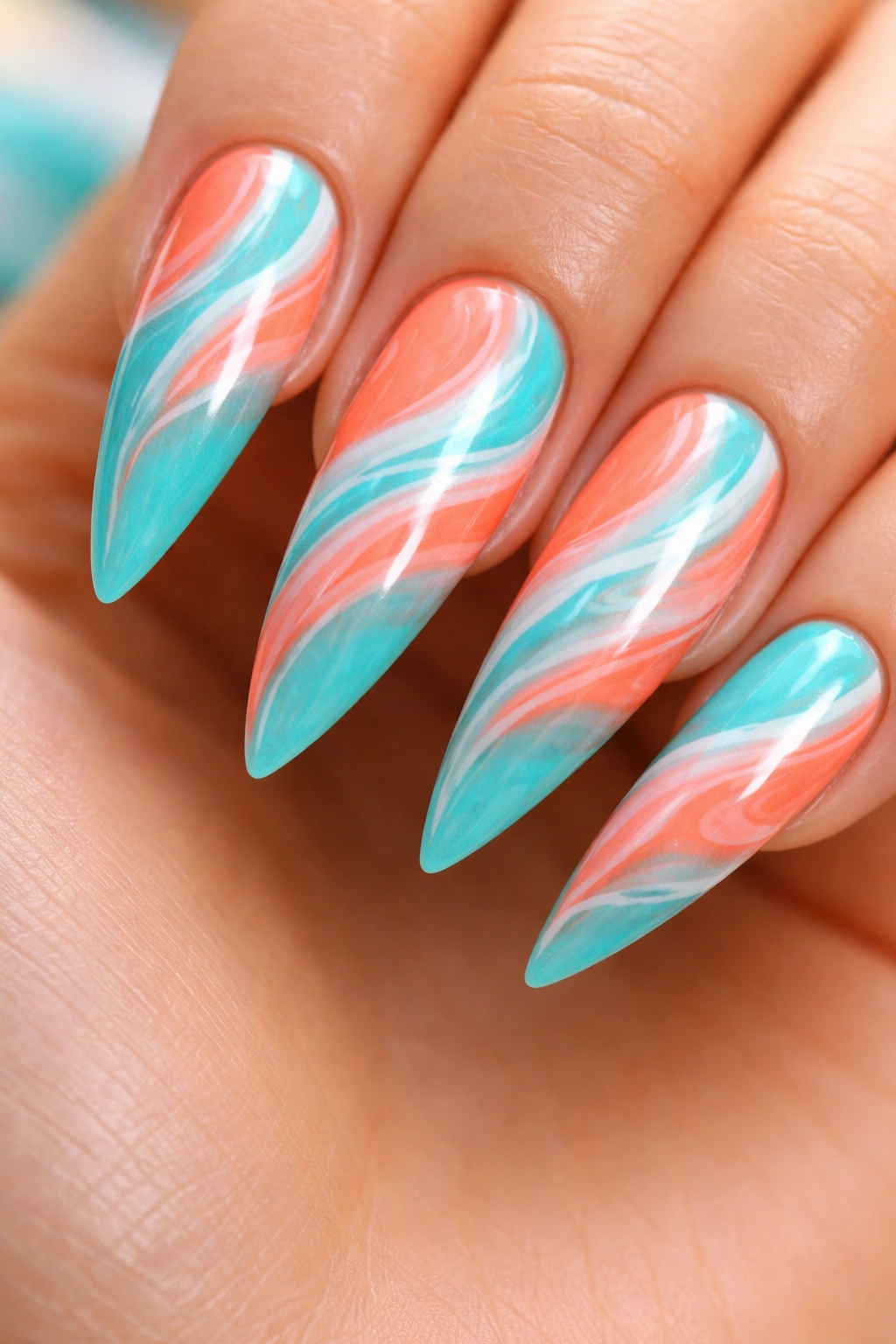 Turquoise stiletto nail with flowing coral and white swirls