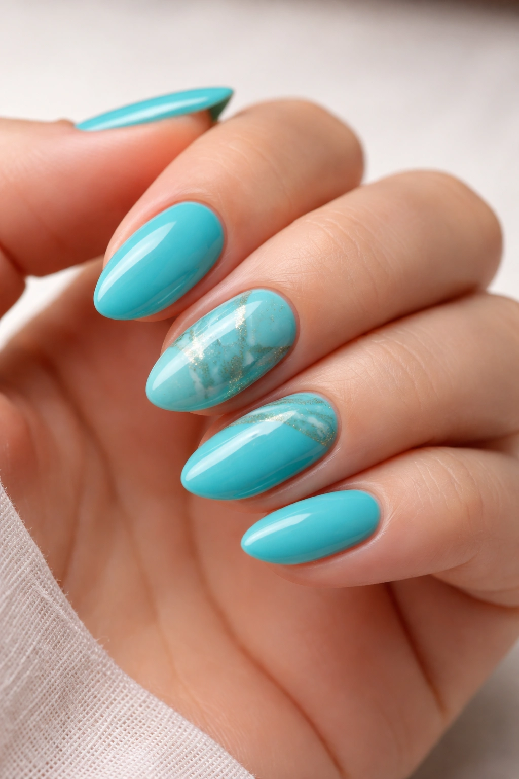 Turquoise marble nails on short almond nails with subtle veining