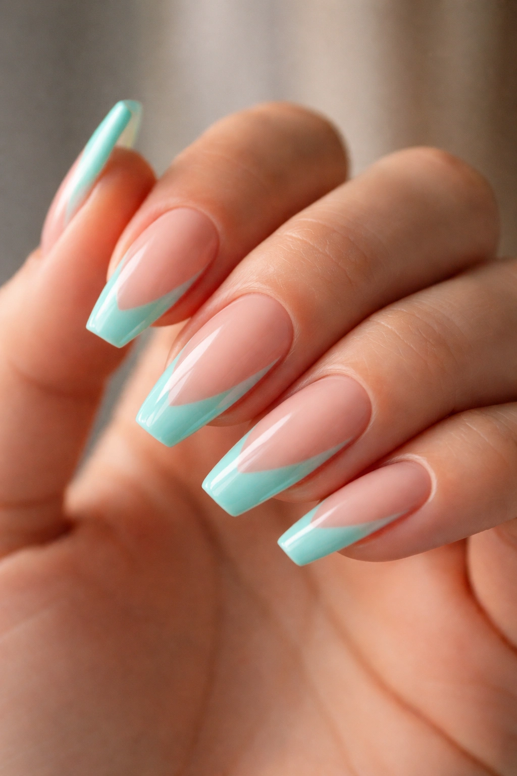 Close-up of turquoise negative-space tips on nails