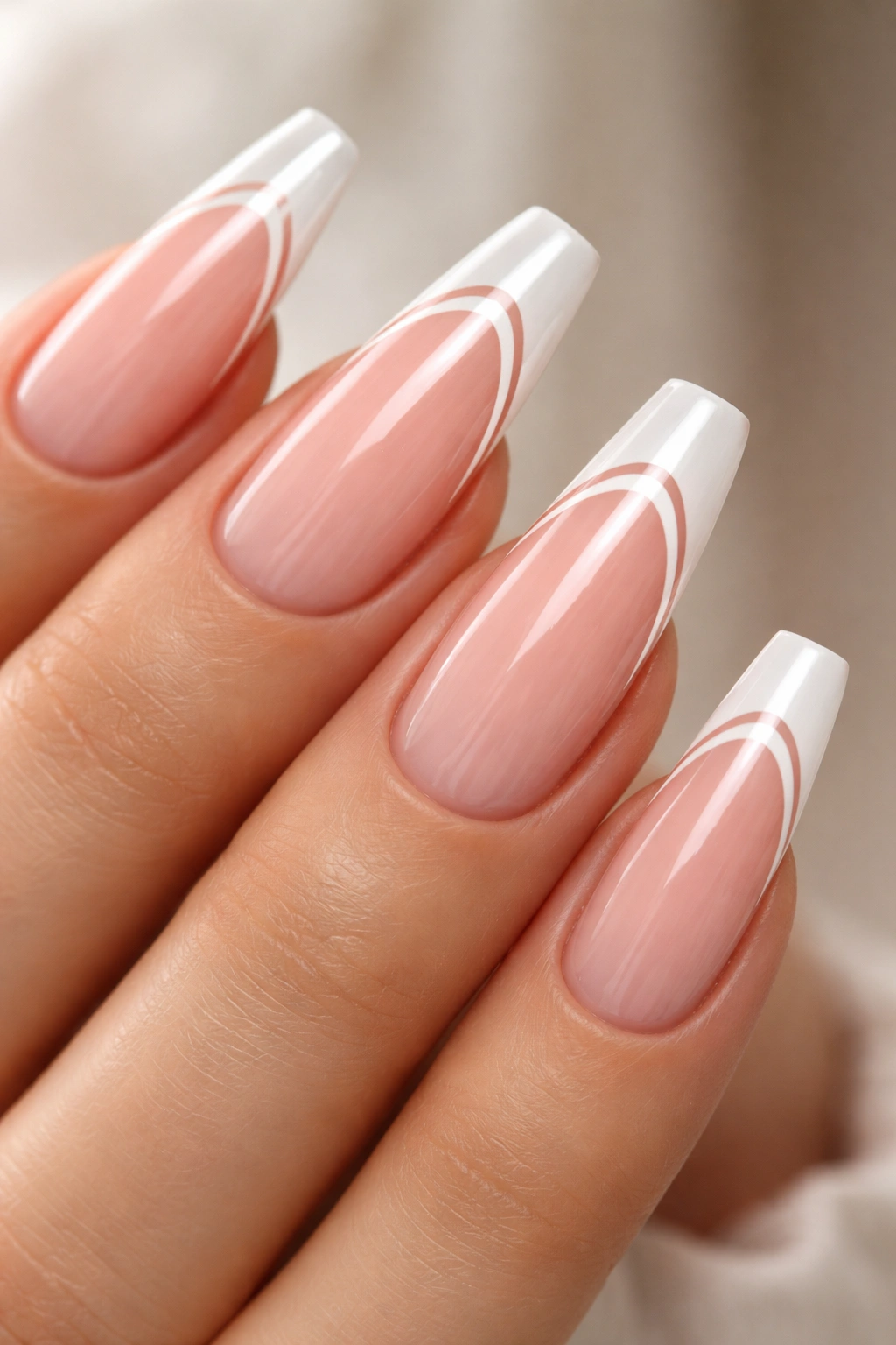 Close-up of ballerina nails with two thin white lines and negative space on milky pink base