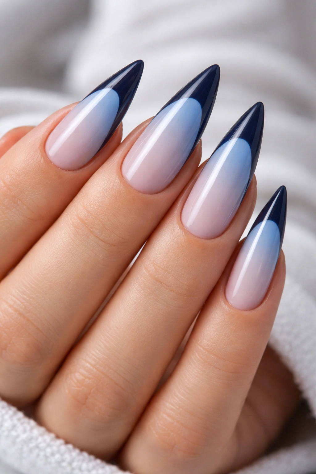Close-up of two-tone blue French tips with light base and dark tip