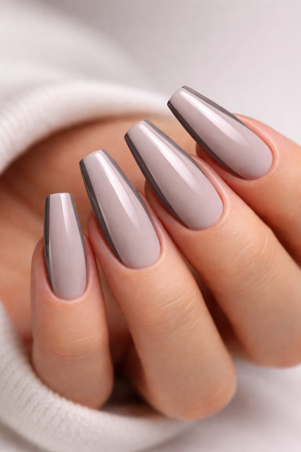 Two-tone grey French nails with dark sidewalls and pale tips on ballerina nails