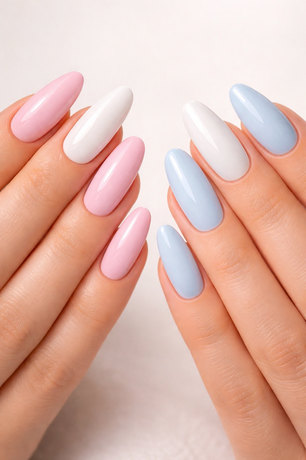 Close-up of two hands showing two-tone acrylic nails with opposite color distribution