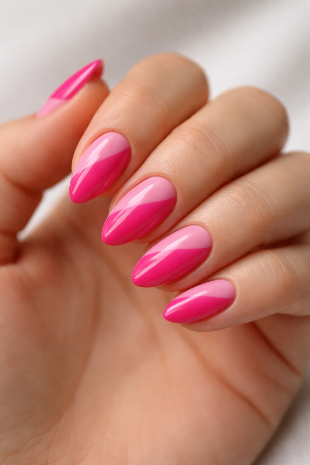 Close-up of two-tone pink almond nails with diagonal split