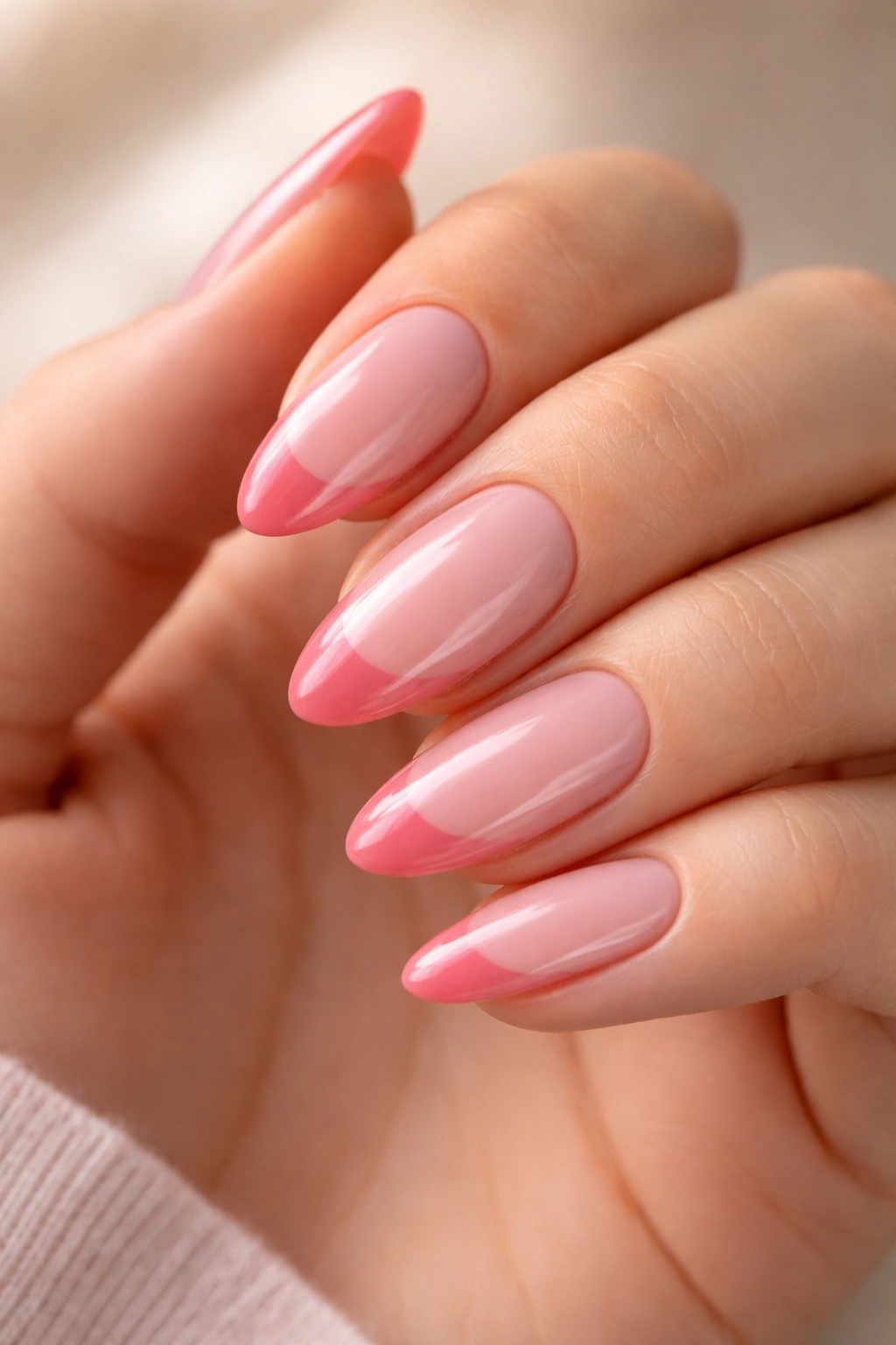 Almond nails showing two-tone pink French tips with color separation.