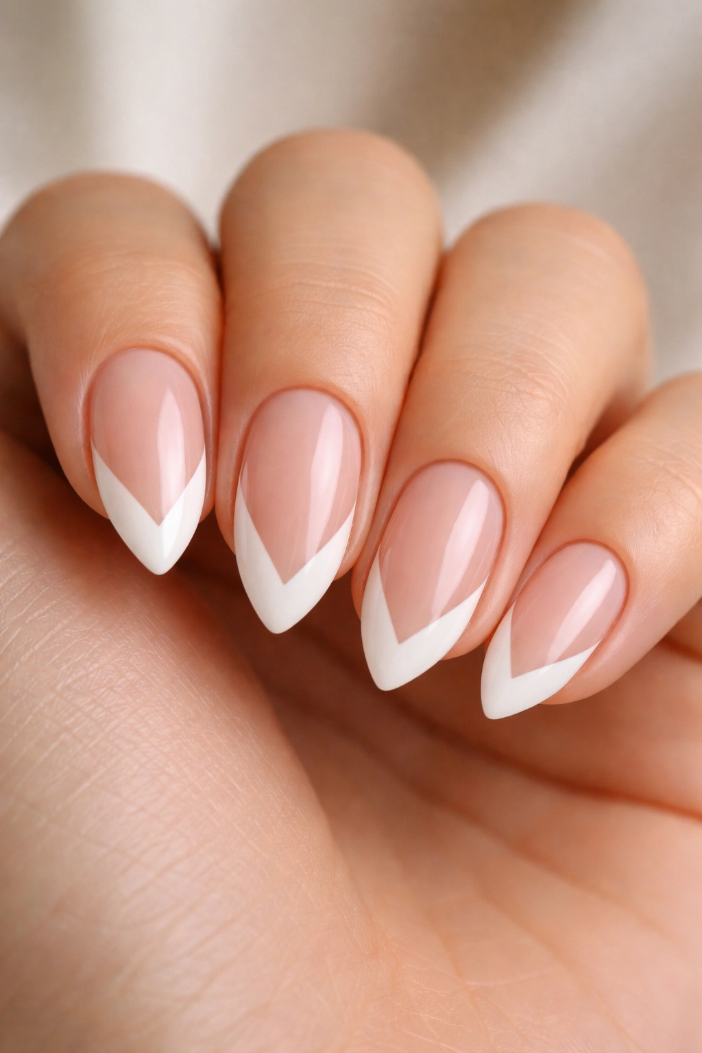 Short almond nails with a V-cut French tip