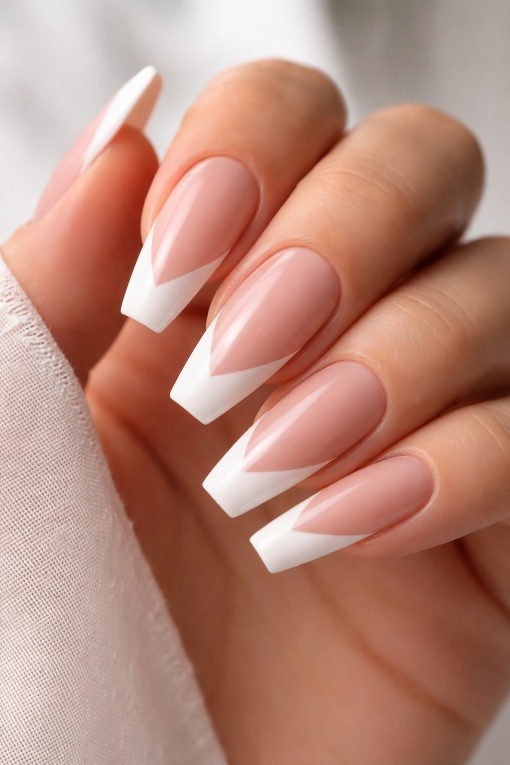 Close-up of ballerina nails with soft V-French on beige-pink base
