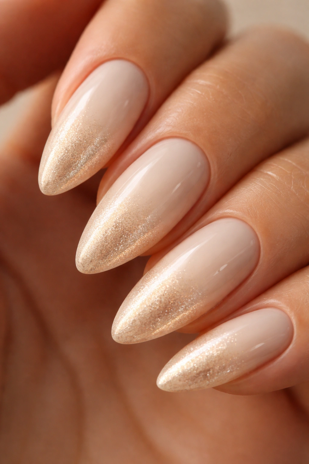 Almond nail with vanilla to champagne ombre and subtle gold shimmer at the tip.