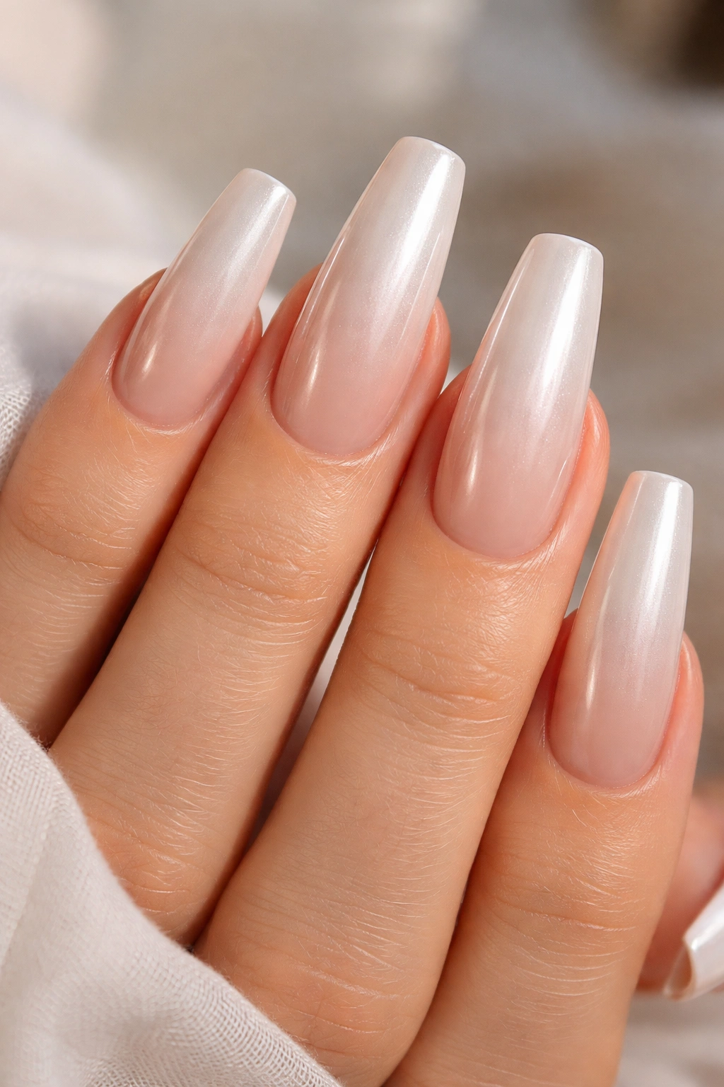 Nude base with sheer vanilla pearl chrome nails glowing softly