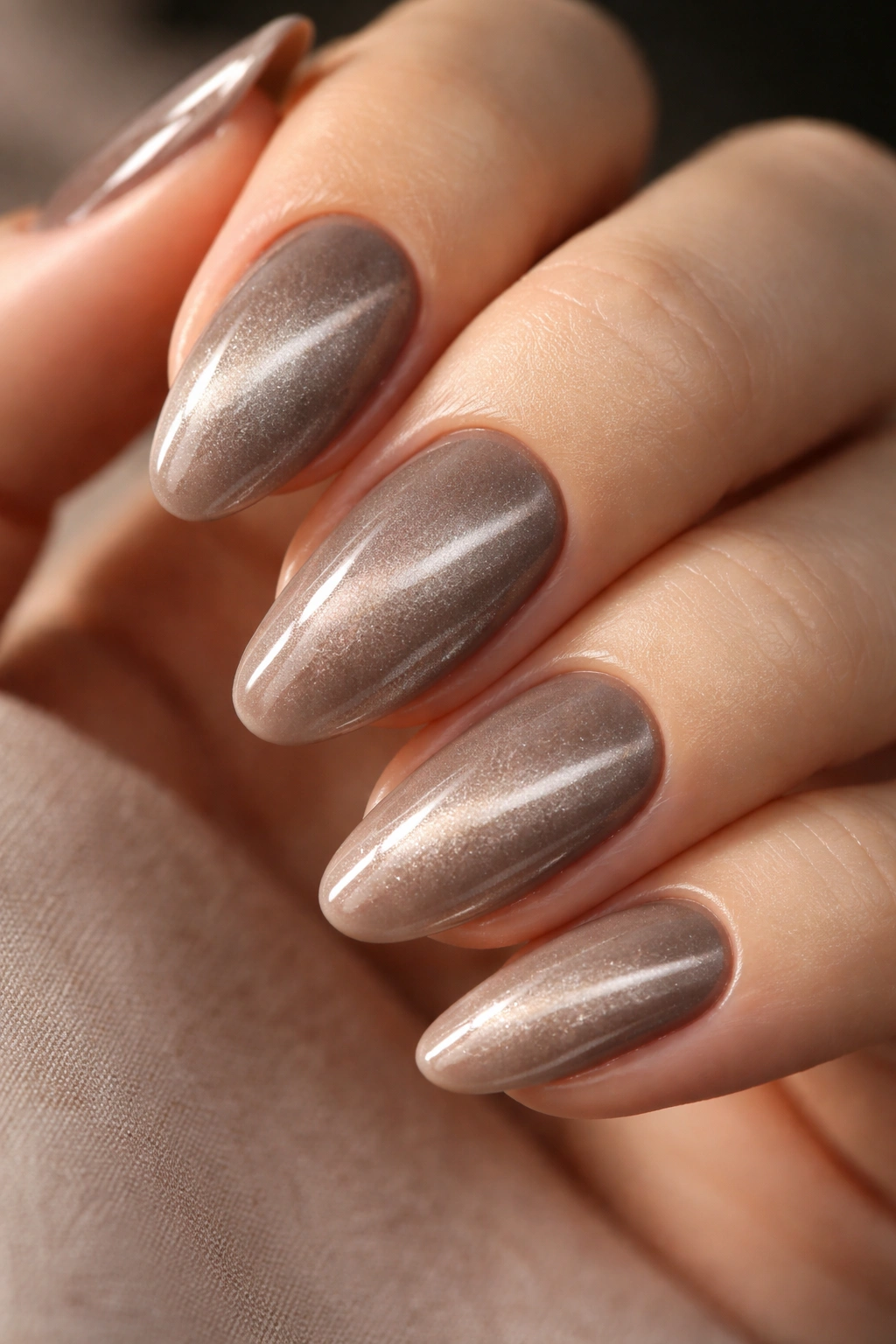 Velvet cat-eye nails with neutral taupe stripe.