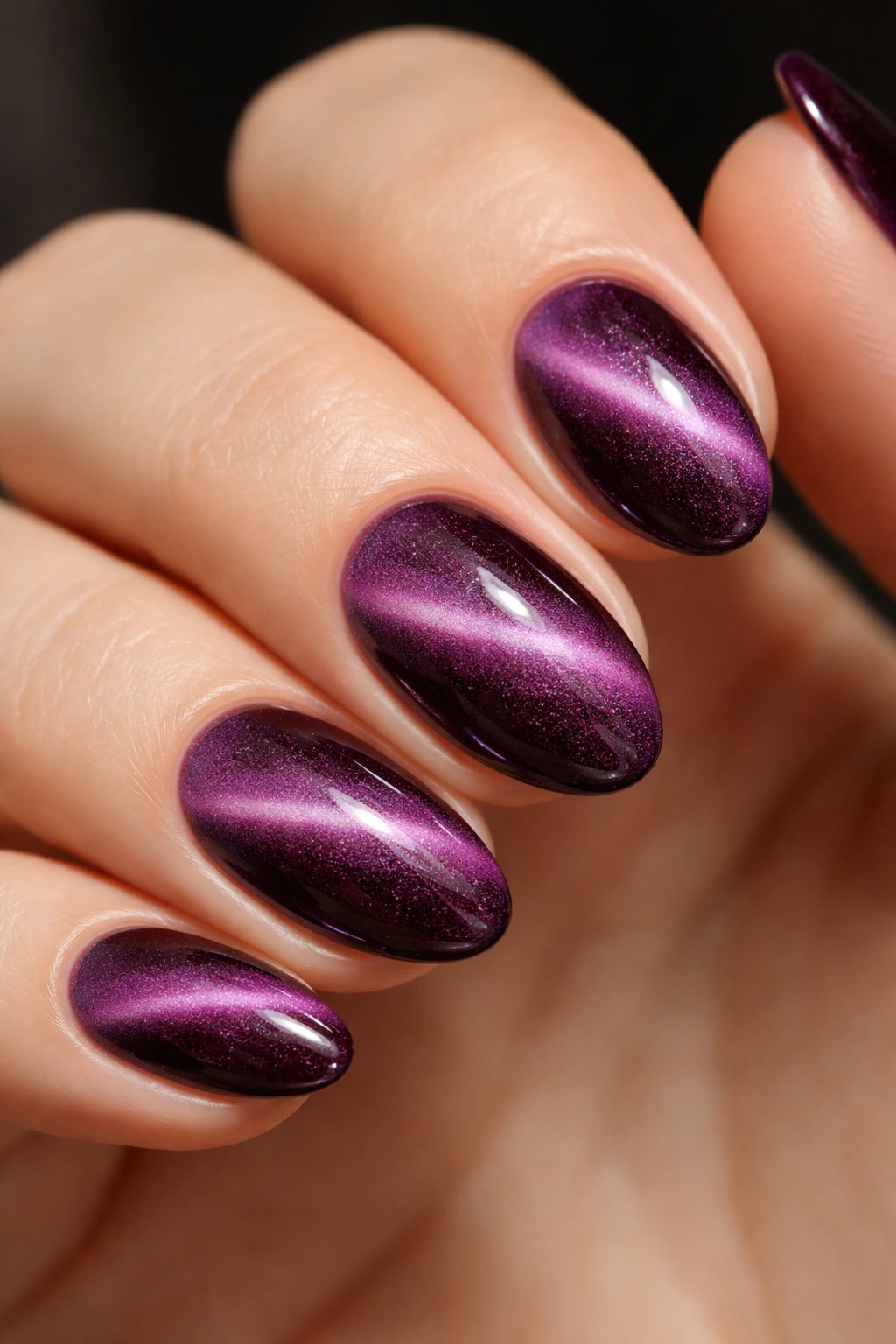 Close-up of velvet plum magnetic nails with fuzzy shimmer