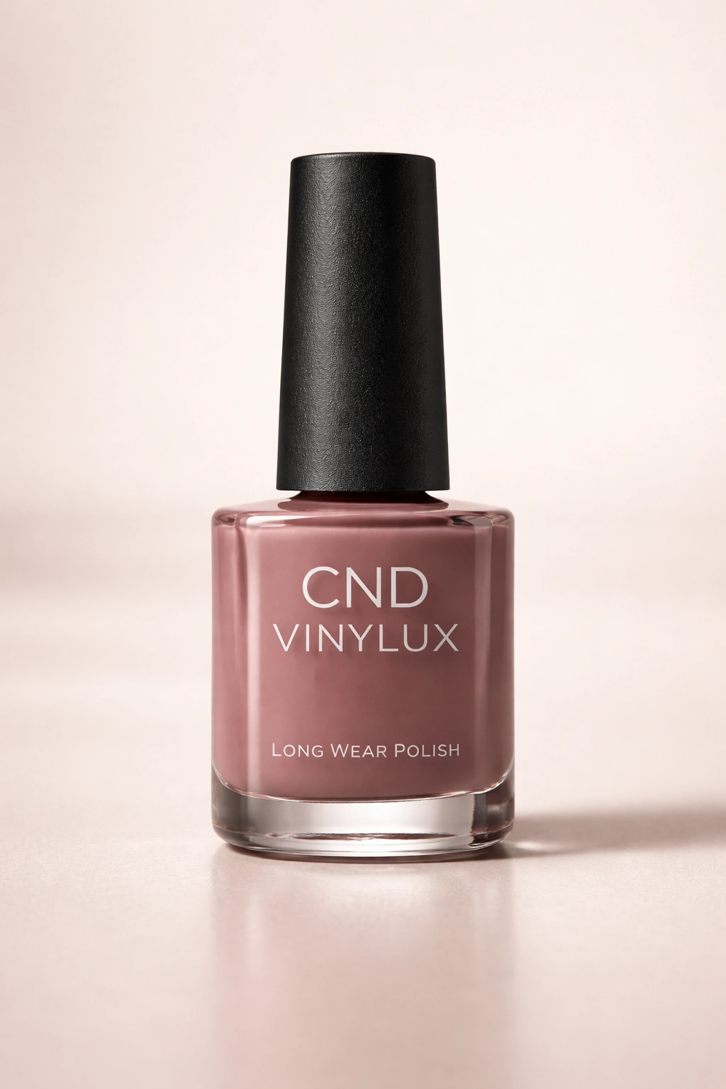 Nail polish bottle silhouette with glossy finish against neutral background, representing CND Vinylux.
