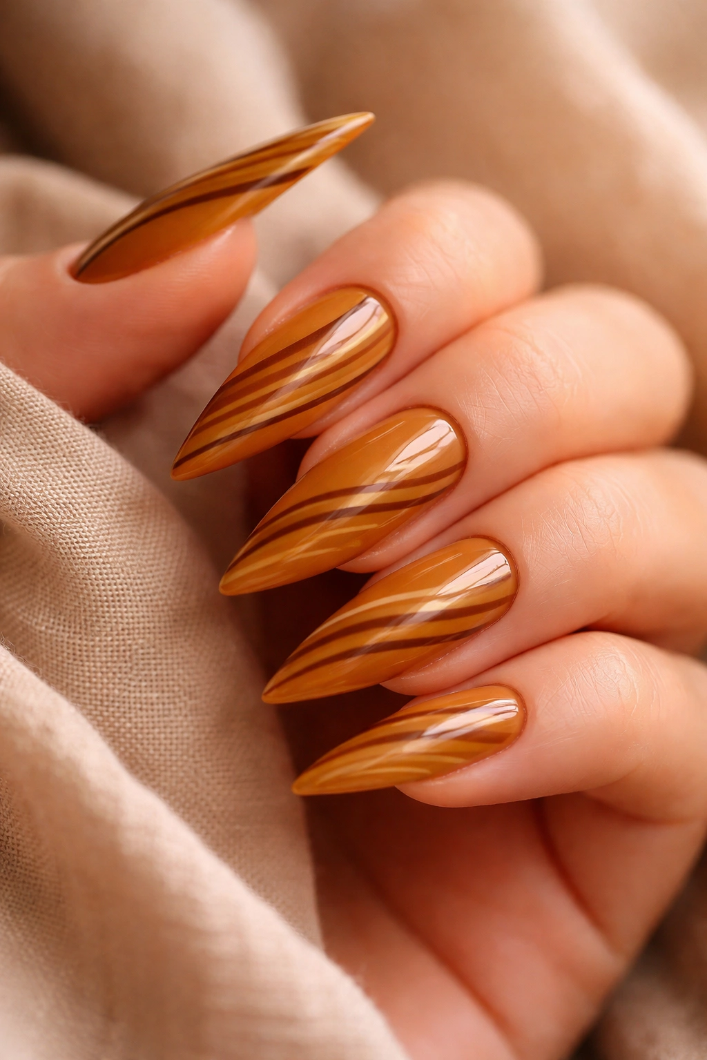 Warm honey nails with thin contrasting stripes