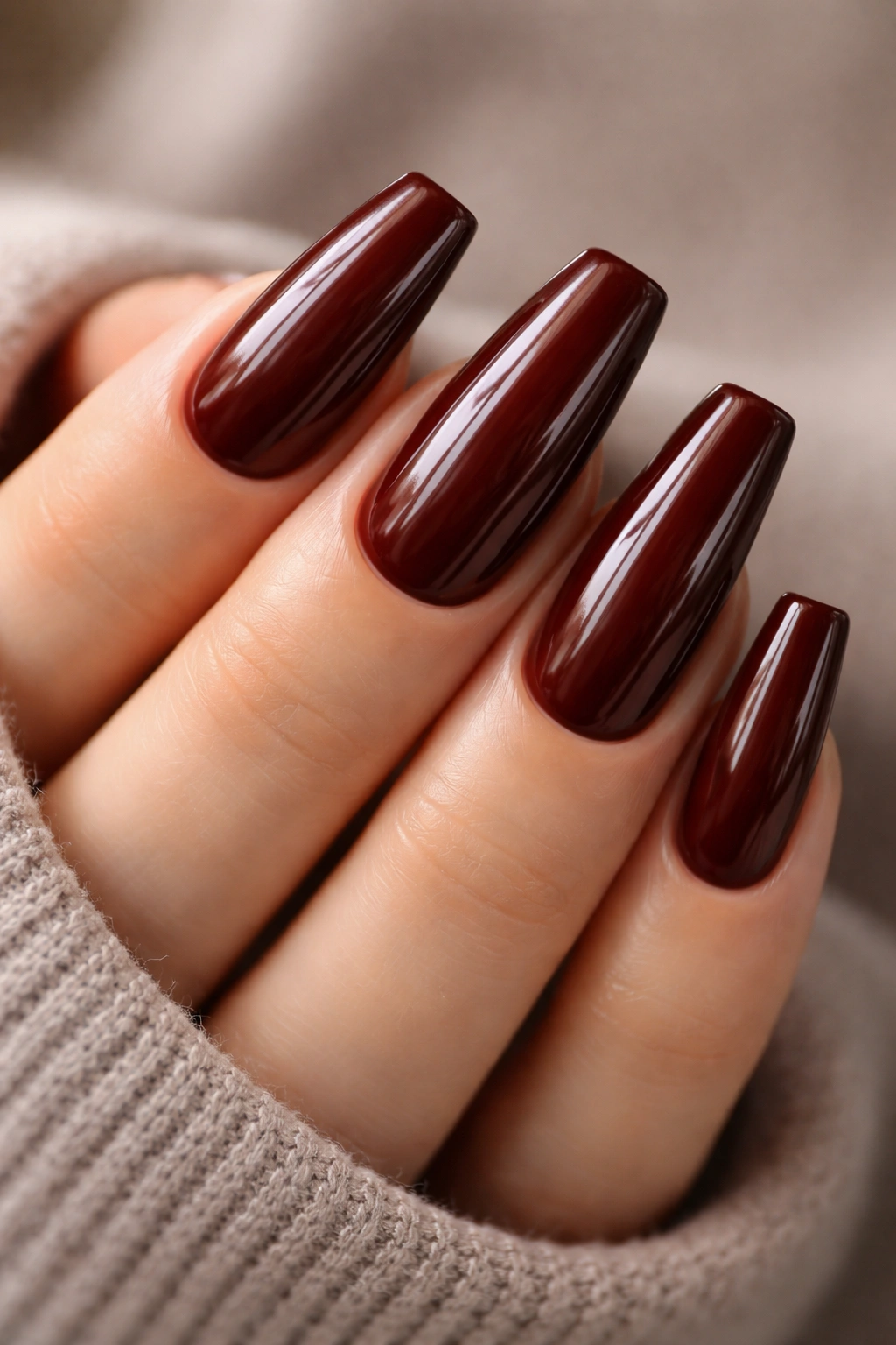 Close-up of medium coffin nails in warm mahogany with glossy finish