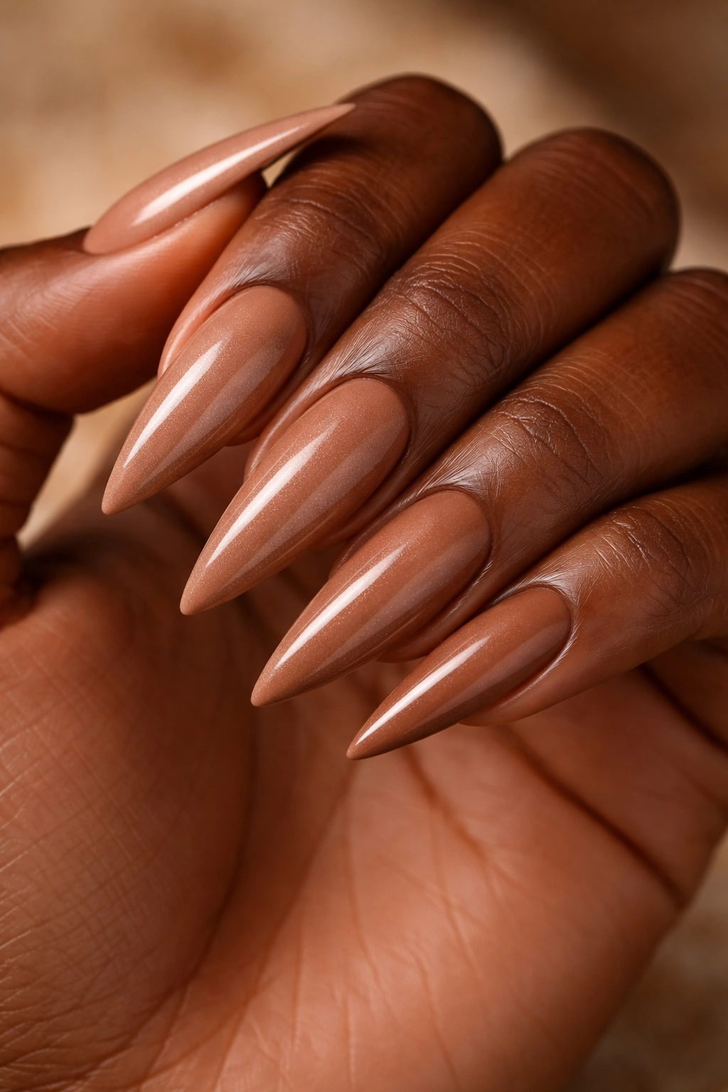 Warm caramel nude stiletto nails with subtle shimmer.