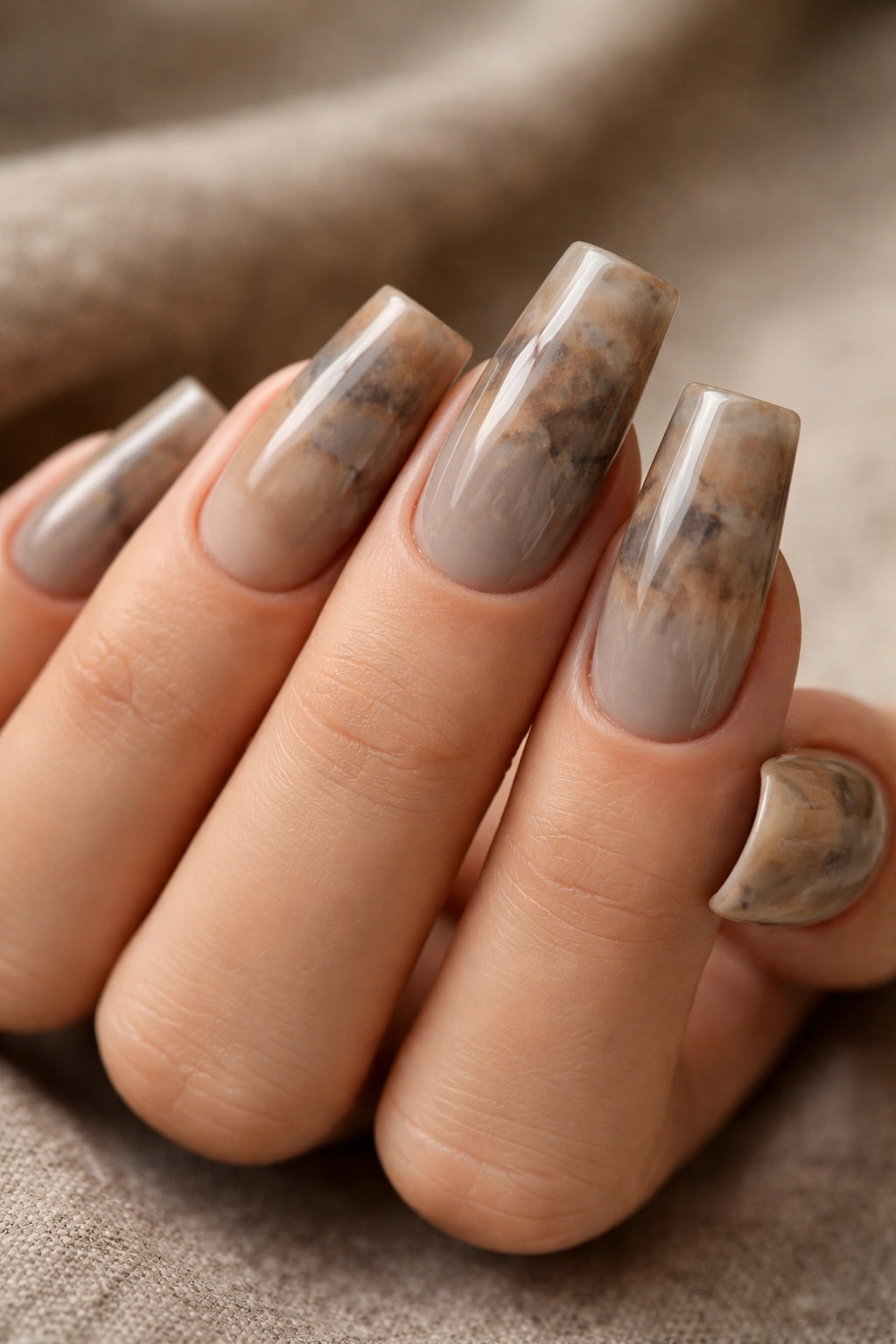 Close-up of duck nails in warm stone shade with earthy depth