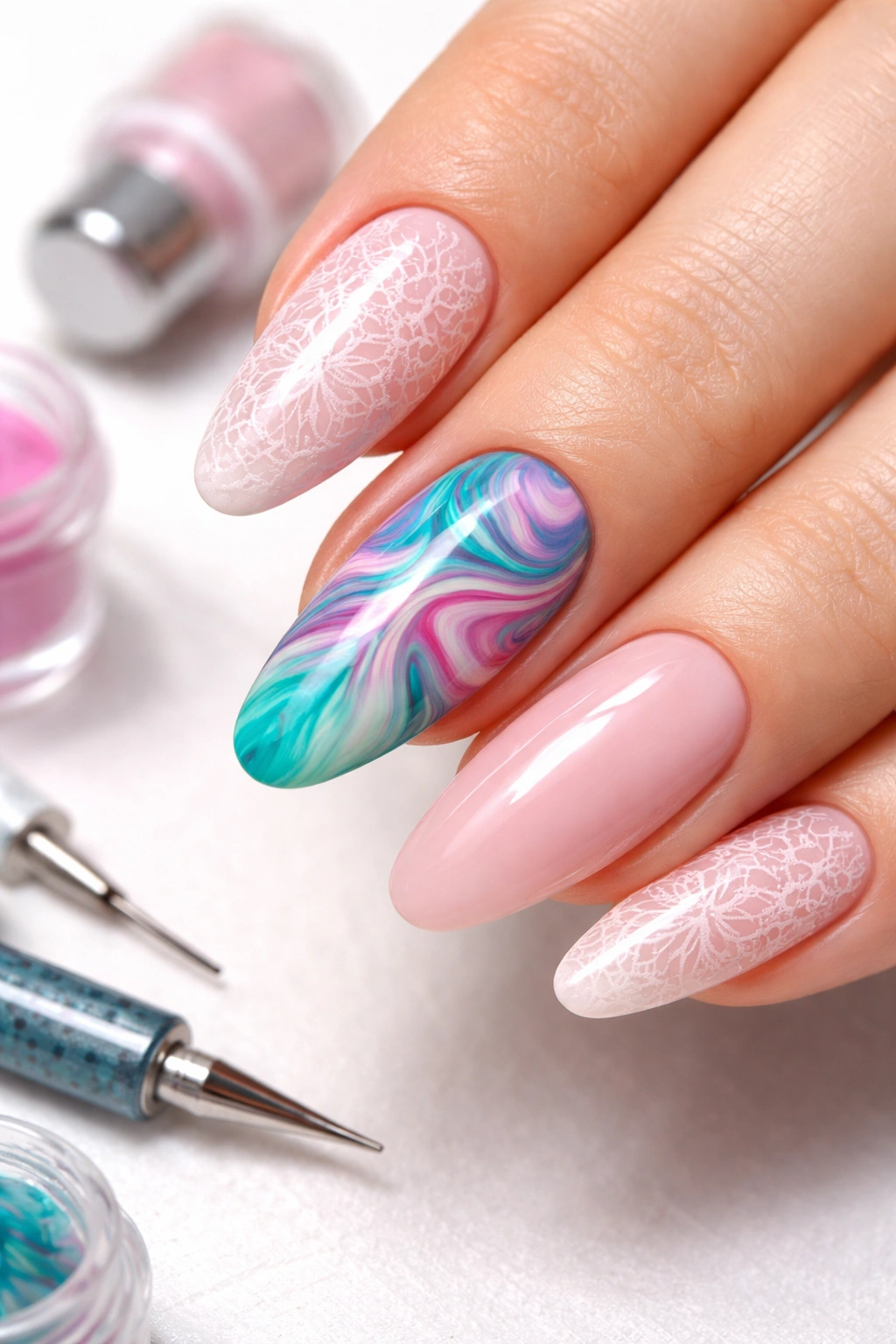 Close-up of a hand with water marble and stamping nail designs in a studio