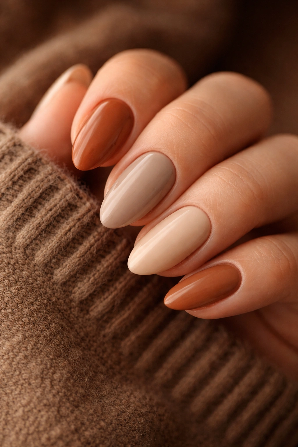 Close-up of nails in earthy western colors such as sand, taupe, rust