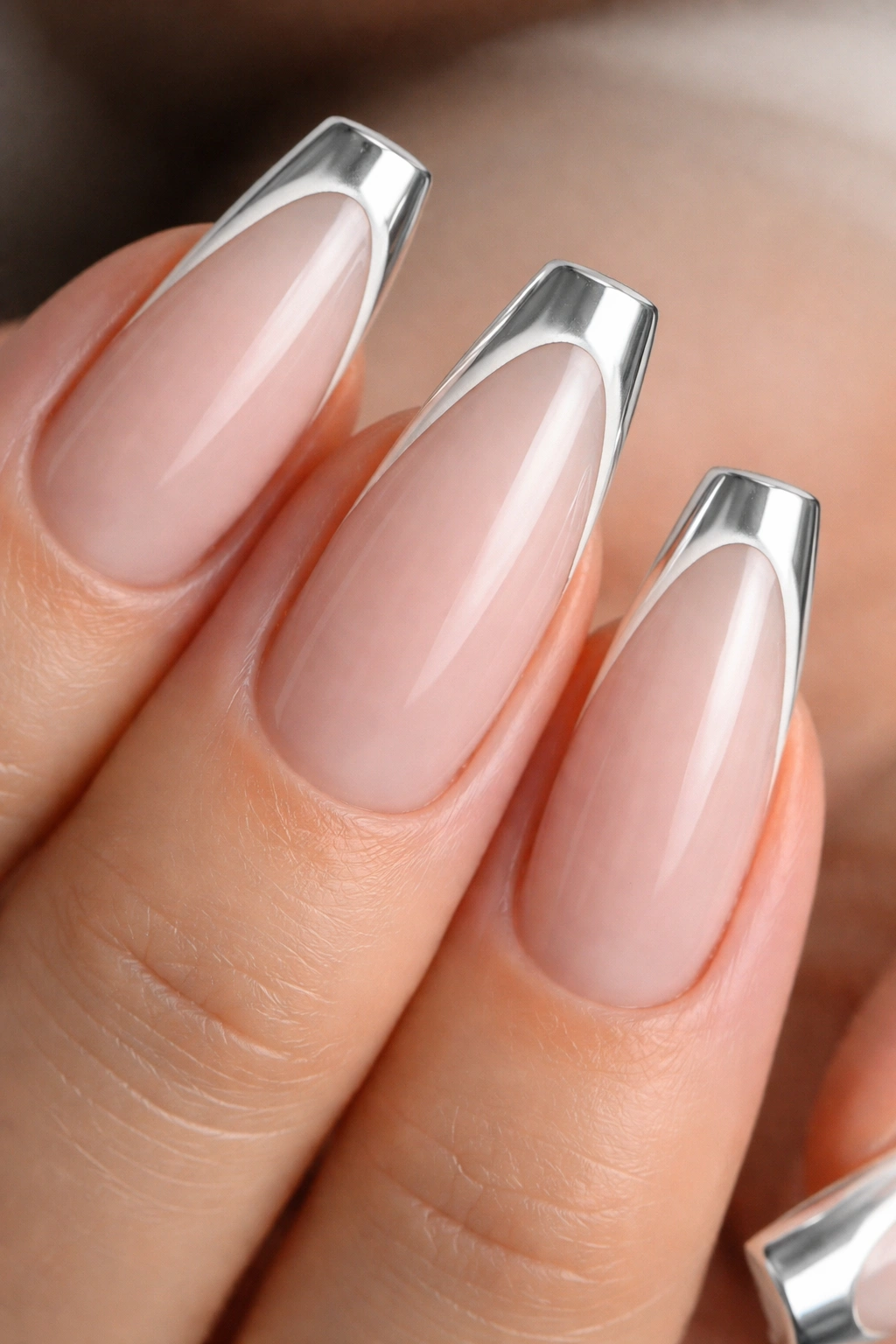Close-up of white chrome French edge on sheer-based ballerina nail