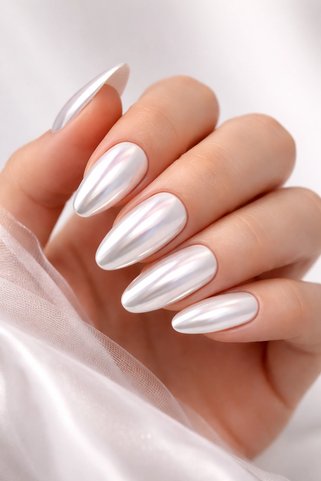 Close-up of white chrome nails reflecting light